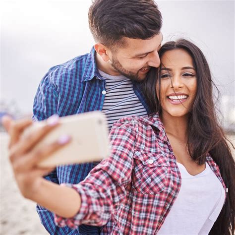 Playful Romantic Couple Taking Selfies Together Playful Romantic Couple Taking Selfies