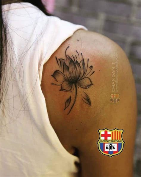A Woman With A Tattoo On Her Shoulder