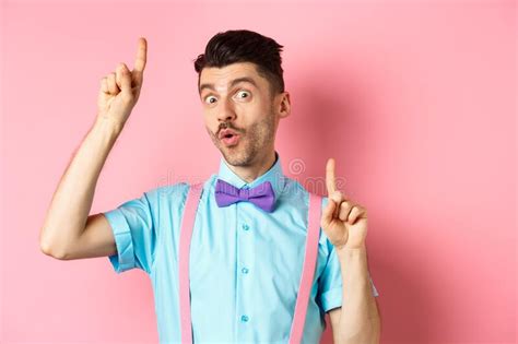 Cheerful Funny Man Dancing In Bow Tie And Suspenders Pointing Fingers Up And Looking Upbeat