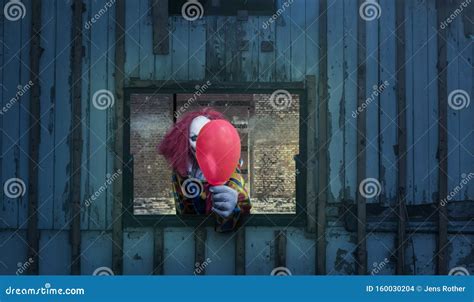 A Clown With A Balloon Looks Out Of A Window Stock Photo Image Of