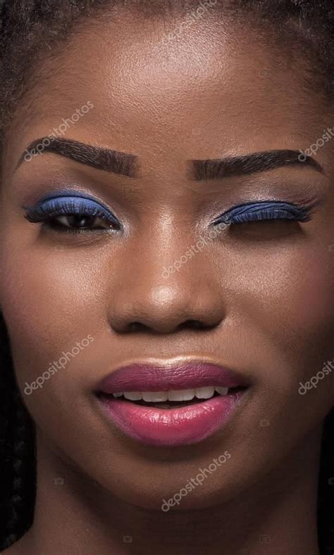 Close Up Portrait Of Dark Skinned Model With One Eye Closed Stock