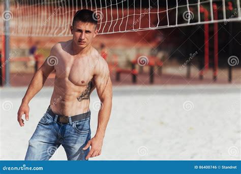 Muscular Male Model With Perfect Body Posing In Blue Jeans Stock Photo