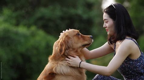 Young Asian Woman With Dog Outdoor By Bo Bo