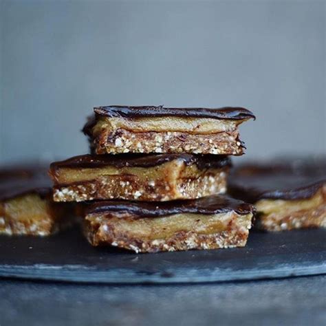 Five Pieces Of Chocolate And Peanut Butter Bars Stacked On Top Of Each