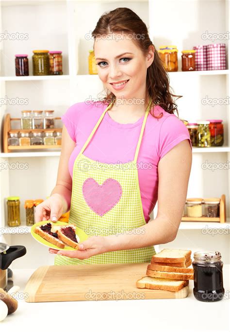 Young Woman Cooking In Kitchen Stock Photo By ©belchonock 24800763