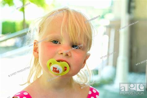 Portrait Of Little Girl With Pacifier Stock Photo Picture And Royalty