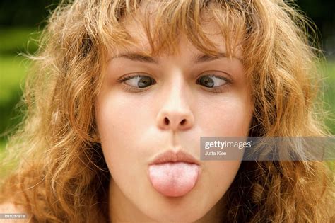 Closeup Of Crosseyed Woman Sticking Out Tongue Photo Getty Images