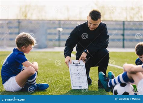 Young Soccer Trainer Coach Explaining Tactic On Team Sports Tactics