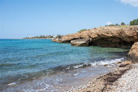 Sea Cave Rock Formation Gravel Beach And Turquoise Water Cyprus Stock