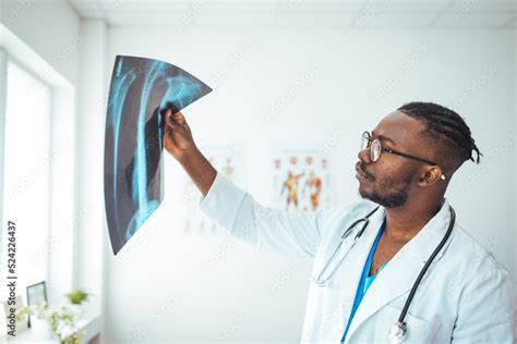 Male Radiologist Analyzing Chest X Ray Of An Patient At Medical Clinic