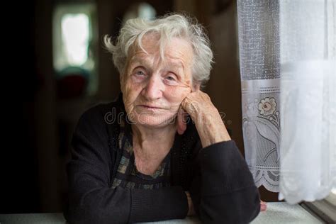 Sad Older Woman Sitting At The Table Stock Photo Image Of Older