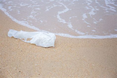 Plastic Trash Bags On The Beach By The Sea In The Morning Stock Photo