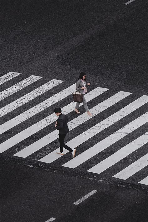 Aerial Graphy Of Man And Woman Walking On Pedestrian Lane During