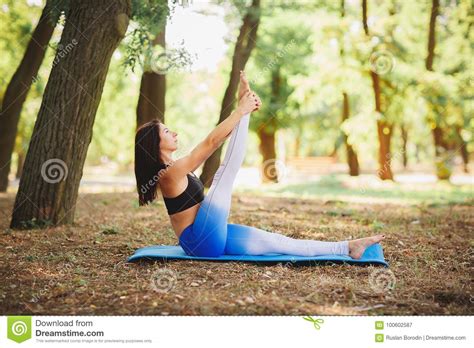 Pretty Woman Doing Yoga Exercises In The Park Young Yoga Teacher