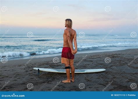 Surfing Man Stretching Surfer On Sandy Beach Going To Surf On