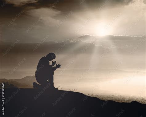 Prayer Kneeling And Praying To God On Mountain Autumn Sunset Background