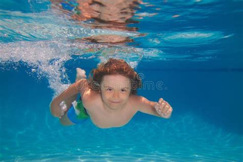 Young Boy Swim And Dive Underwater Under Water Portrait In Swim Pool