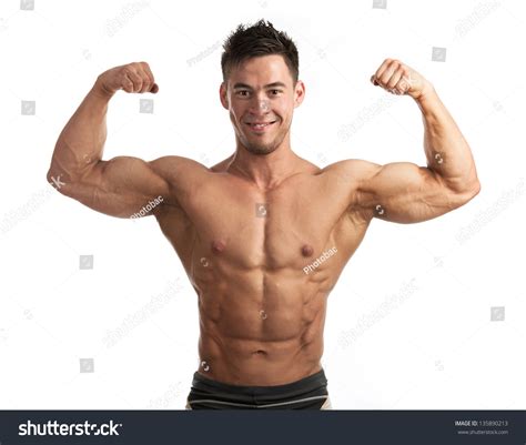 Waist Up Portrait Of Muscular Man Flexing His Biceps Against White