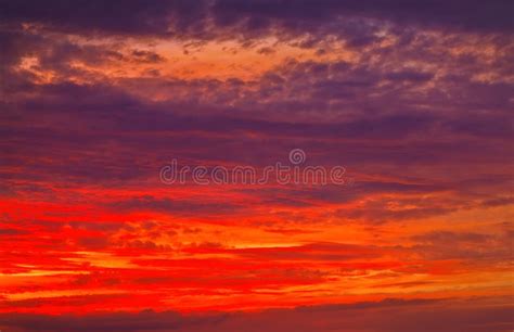 Colorful Fiery Red Sunset And Solar Pillar Effect View Of Power Lines
