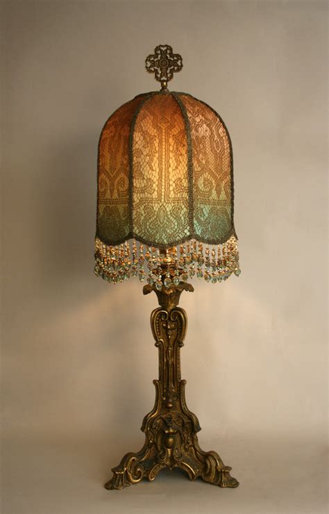 Clear glass with etched design and the top portion in a burnt orange color. Nightshades - antique gold candlestick lamp with custom shade