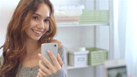 Smiling Woman Taking Mobile Selfie Photo On Phone At Bathroom Mirror