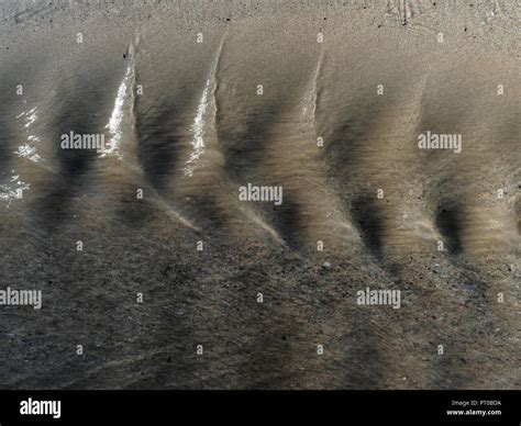 Close Up Of Water Ripples Over Sand Beach Stock Photo Alamy