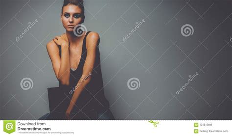Beautiful Woman Sitting A Chair Isolated On Gray Background Stock