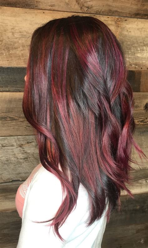 Get your long hair cut in layers and complement it with some deep red highlights to add some depth and dimension to it. Hair Services | Triniti Salon, Cary NC