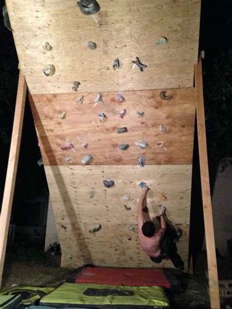 There Is A Climbing Wall Made Out Of Plywood Planks And Wood With Some