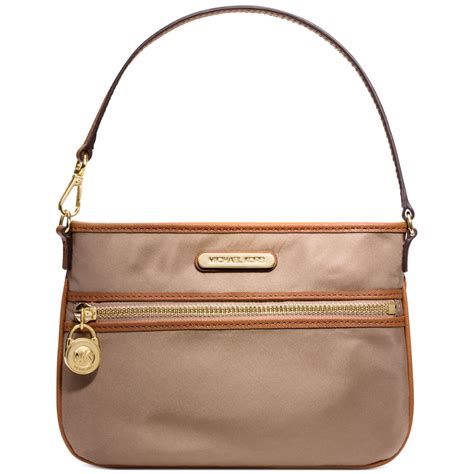 The saffiano leather construction provides luxe durability, while the thin strap is. Michael Kors Kempton Wristlet in Beige (DUSK) | Lyst