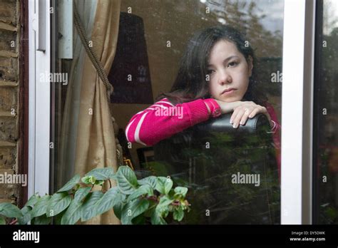 Girl Looking Through Window Stock Photo Alamy