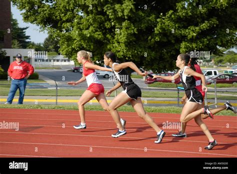 Teenage Girl Relay Race Runners At A High School Track And Field Stock