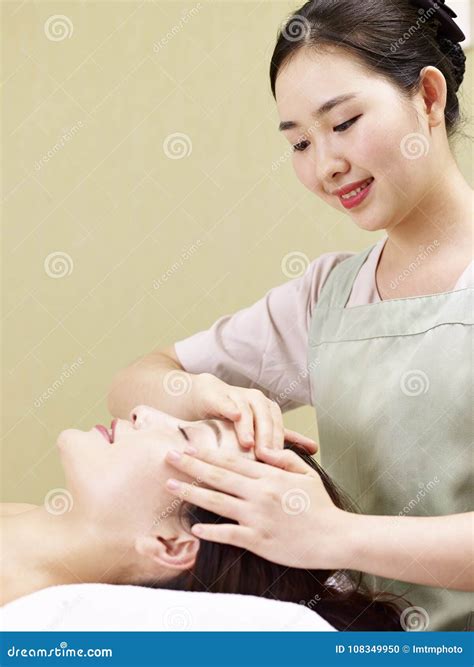 Giovane Massaggiatore Asiatico Che Realizza Massaggio Di Fronte Sulla Donna Fotografia Stock