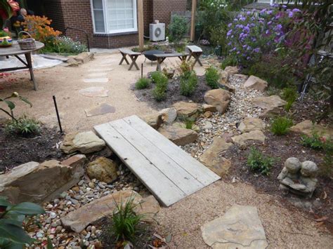 Dry Creek Bed With Timber Bridge Creates A Very Rustic Feel In This