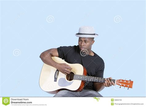 Papa charlie mccoy, ishman bracey. Young African American Man Playing Guitar Over Light Blue ...