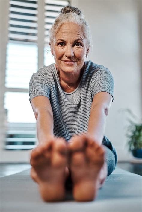 Oh Hello There Portrait Of A Cheerful Mature Woman Practicing Yoga