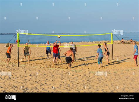 People Having Fun Playing Beach Volleyball At Sandbanks Beach Poole