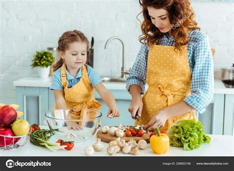Cute Daughter Helping Mother Cooking Vegetables Kitchen Stock Photo By