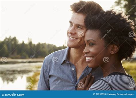 Happy Mixed Race Couple Admiring A View In The Countryside Stock Image