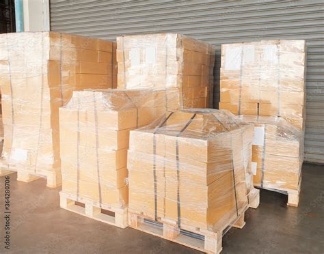 Stack Of Package Boxes Wrapping Plastic On Wooden Pallets Shipment Cargo Export Warehouse