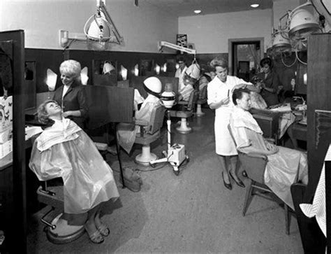 An Old Black And White Photo Of People In A Hair Salon