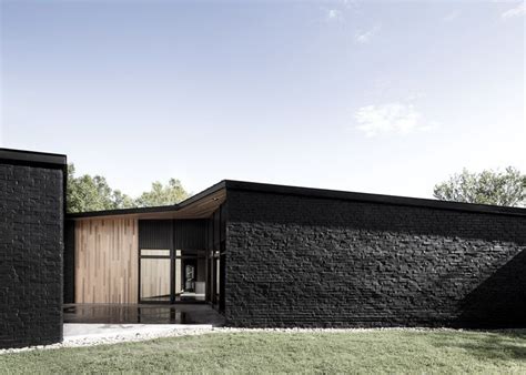 Sprawling House By Alain Carle Contrasts Black Brick With Warm Cedar