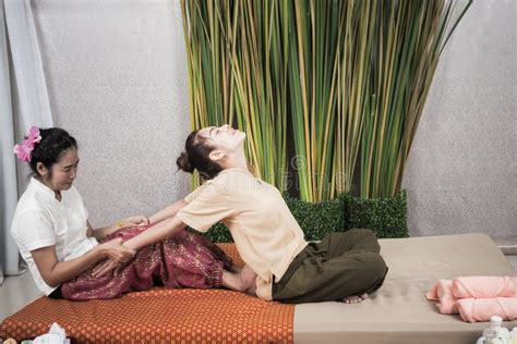 thai masseuse doing massage for woman in spa salon asian beautiful woman getting thai herbal