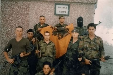 Drafted Members Of The Yugoslav Army Holding A Captured Kla Flagborder