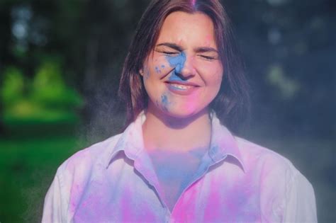 Premium Photo Closeup Shot Of Smiling Woman With Short Hair Posing With Exploding Blue Holi