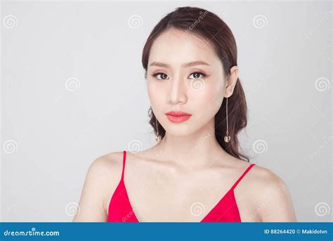 Beautiful Stylish Asian Woman Wearing Red Dress On Grey Background