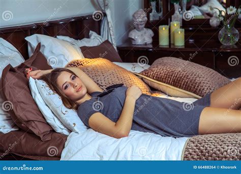 Beautiful Young Happy Fashion Caucasian Model Posing On Bed Stock
