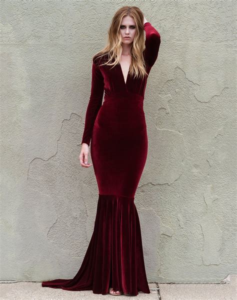 Rich Red Wine Velvet Gown With A Plunging Neckline And Ruched Detailing At The Shoulders Has