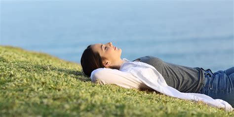Relaxed Woman Resting On The Grass In The Coast Ask The Scientists