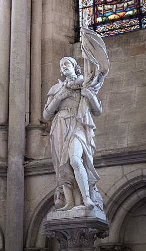 Statue Of Joan Of Arc Holding Her Flag With Her Arm Crossed Across Her